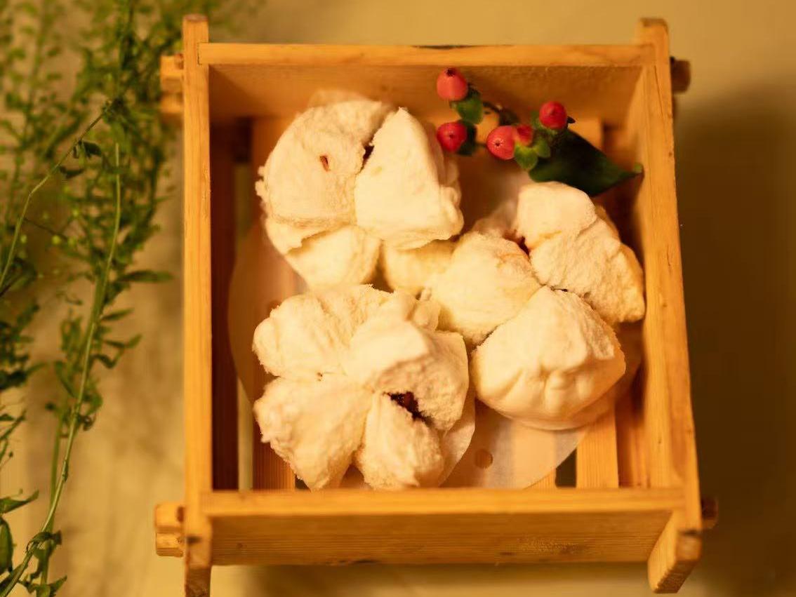 Flower - shaped steam bun with filling served in wooden box at HK Bistro, a Chines Hong Kong Restaurant in Portland