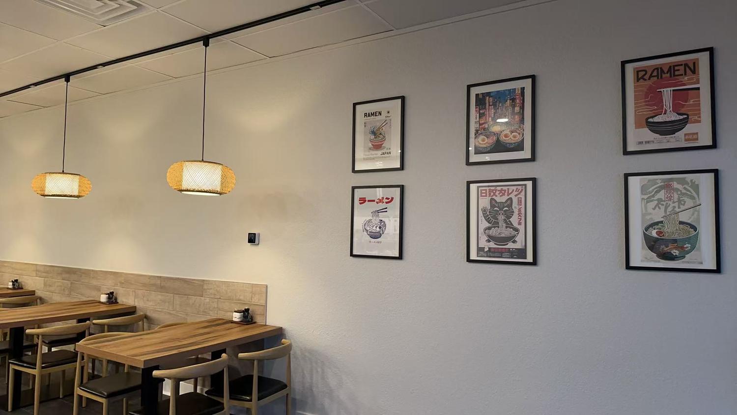 Hokkaido-Ramen-Japanese-restaurant-Dining-Area-Kill-Devil-Hills Dining Area - Simple, bright space with wooden tables and ramen - themed wall decorations at Hokkaido Ramen, a Japanese restaurant in Kill Devil Hills