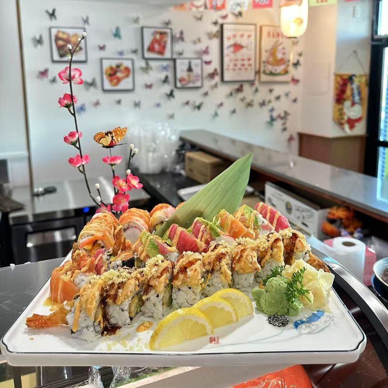Hokkaido-Ramen-&-Sushi-Japanese-Restaurant-Mixed-Sushi-Platter-Lubbock A variety of sushi rolls and slices, beautifully arranged on a large plate.