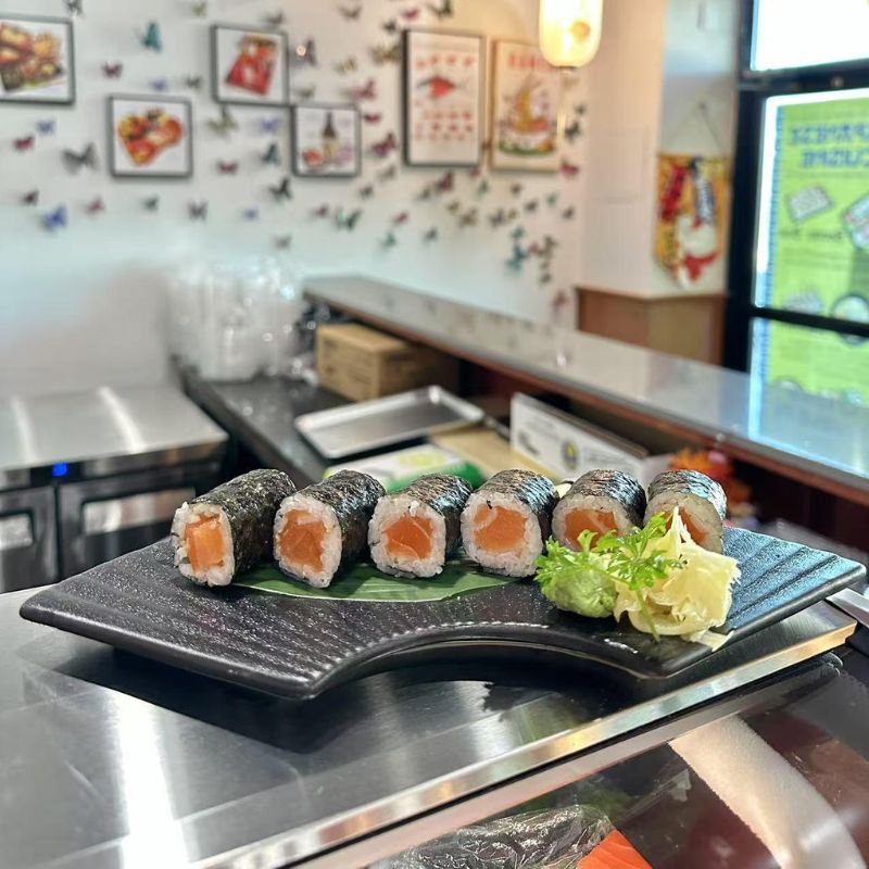 Simple salmon maki sushi served with ginger and wasabi.