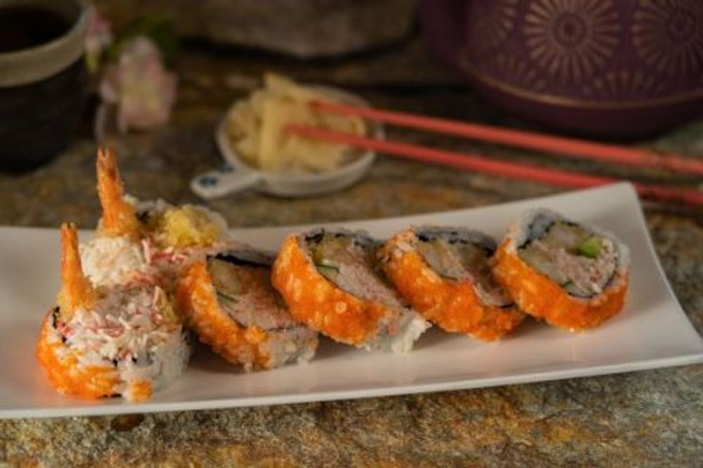 Crunchy tobiko tempura sushi roll with whole fried shrimp tail garnish at Hokkaido Sushi Bar, a Japanese Restaurant in Vancouver