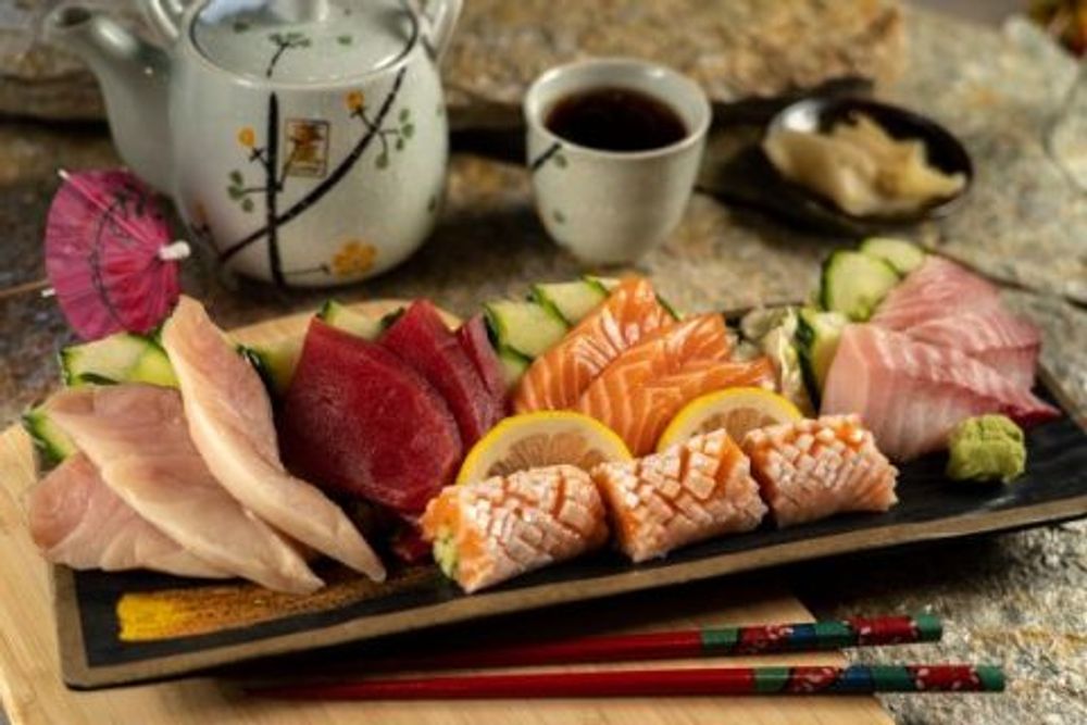 Assorted fresh sashimi platter with salmon, tuna, white fish, lemon and wasabi at Hokkaido Sushi Bar, a Japanese Restaurant in Vancouver