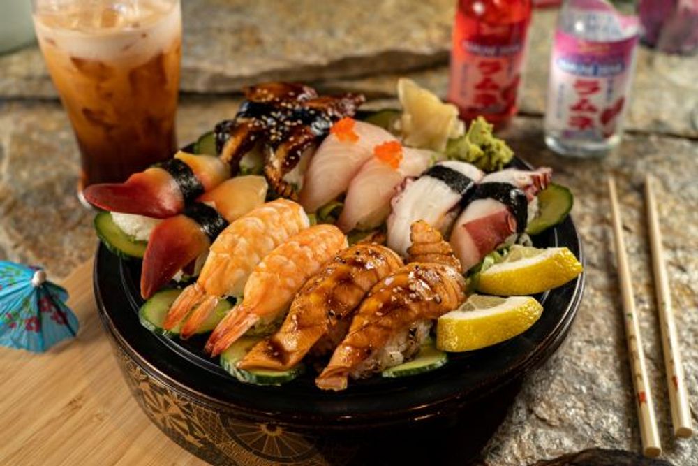 Assorted premium nigiri sushi platter with shrimp, octopus and surf clam paired with iced tea at Hokkaido Sushi Bar, a Japanese Restaurant in Vancouver