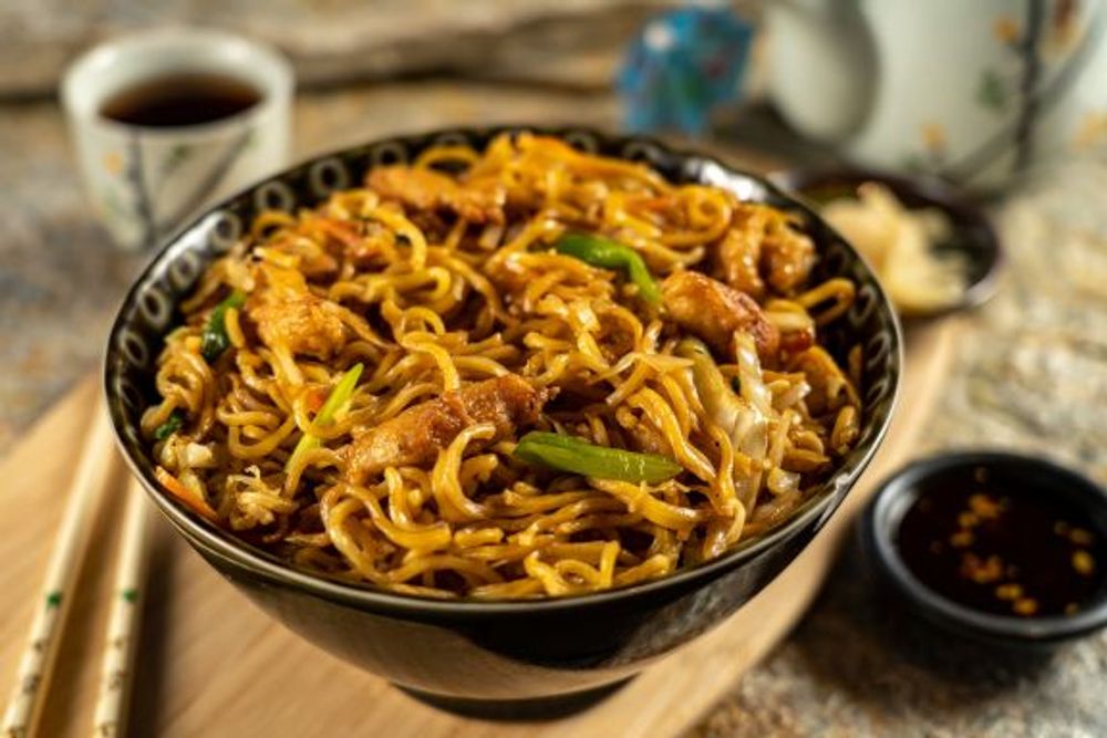 Savory pork lo mein stir-fried noodle bowl with cabbage, green onion and bean sprouts at Hokkaido Sushi Bar, a Japanese Restaurant in Vancouver