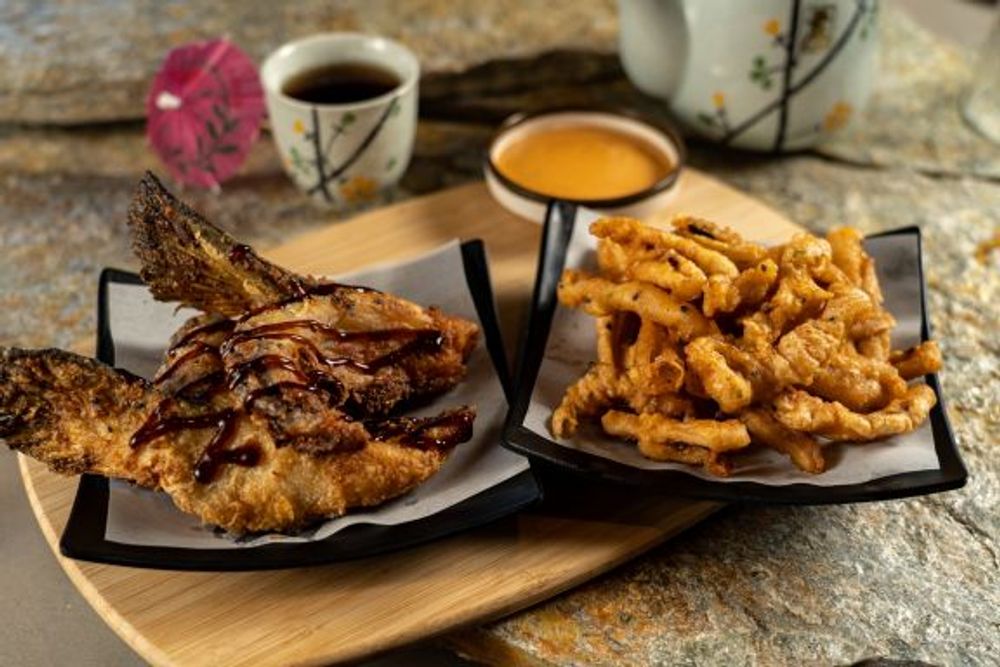 Crispy fried whole fish with teriyaki glaze and tempura vegetable strips at Hokkaido Sushi Bar, a Japanese Restaurant in Vancouver