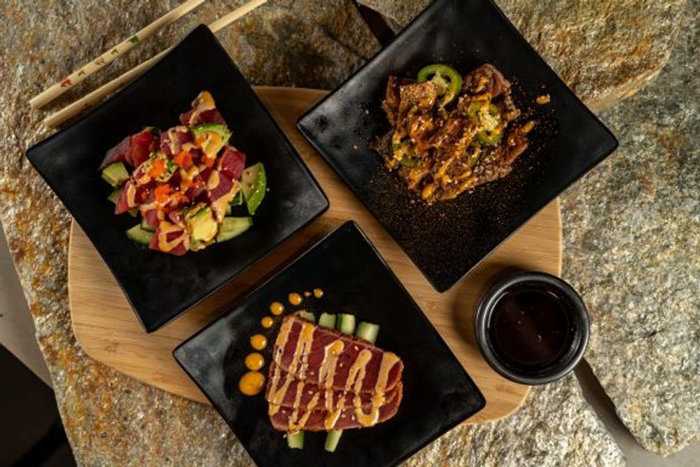 Three small plates of tuna poke, spicy beef and seared tuna with creamy sauce drizzle at Hokkaido Sushi Bar, a Japanese Restaurant in Vancouver