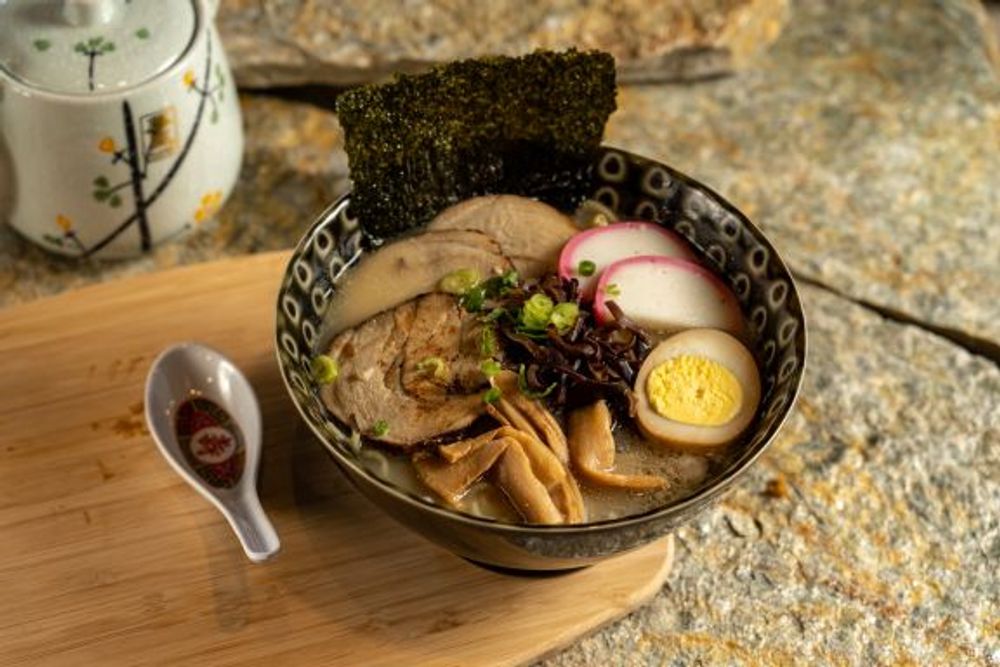Tonkotsu ramen topped with roasted seaweed sheet, chashu and seasoned bamboo shoots at Hokkaido Sushi Bar, a Japanese Restaurant in Vancouver