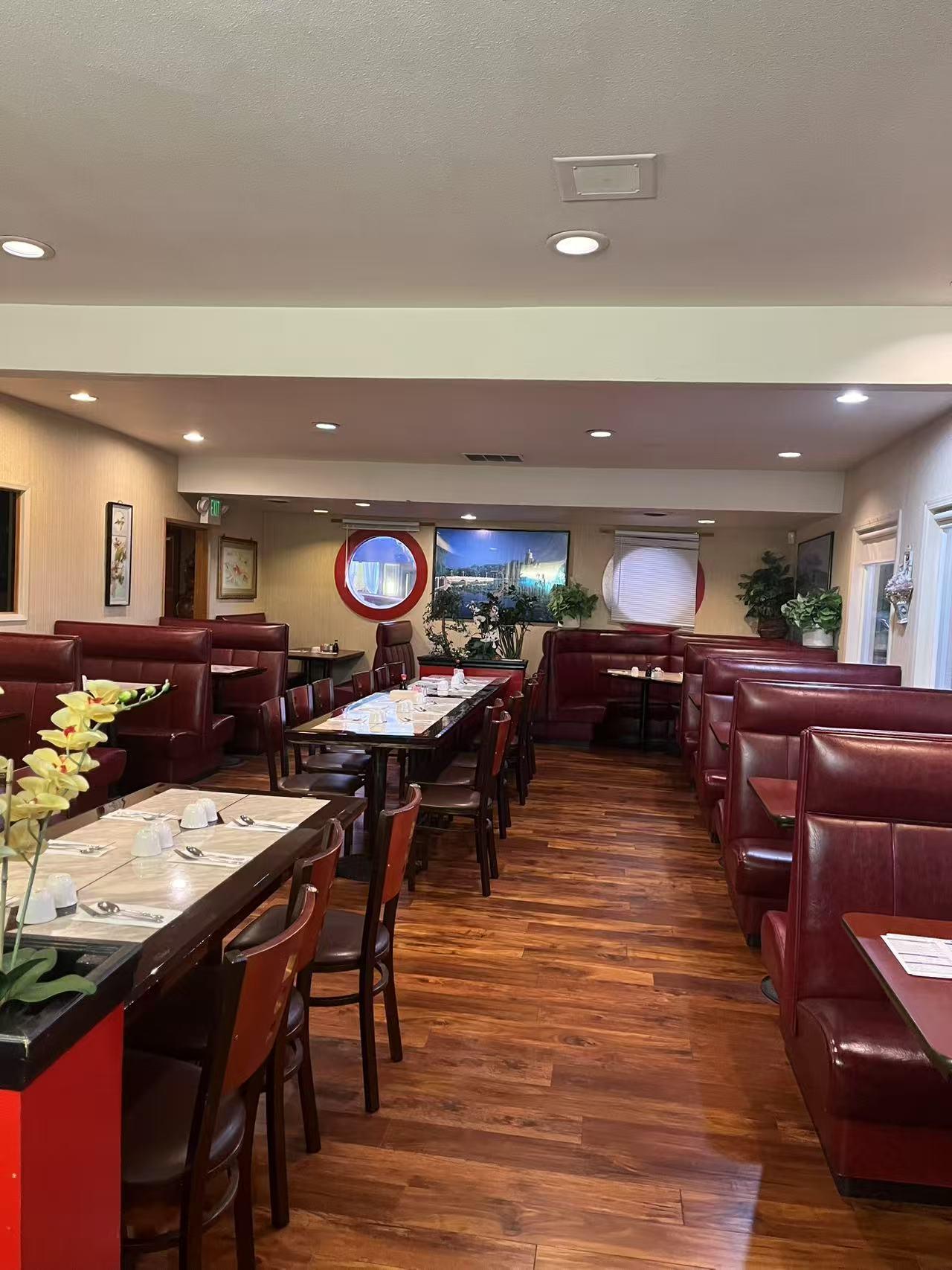 Neat dining area with wooden floors and red booths at Hong Kong Garden Restaurant, a Chinese restaurant in Anacortes