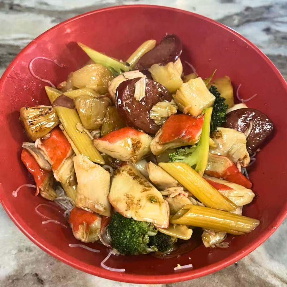A stir-fry bowl with crab, sausage, various vegetables, and glass noodles at Hot Bowl Mongolian Grill, a Mongolian Barbecue Restaurant in Sugar Land
