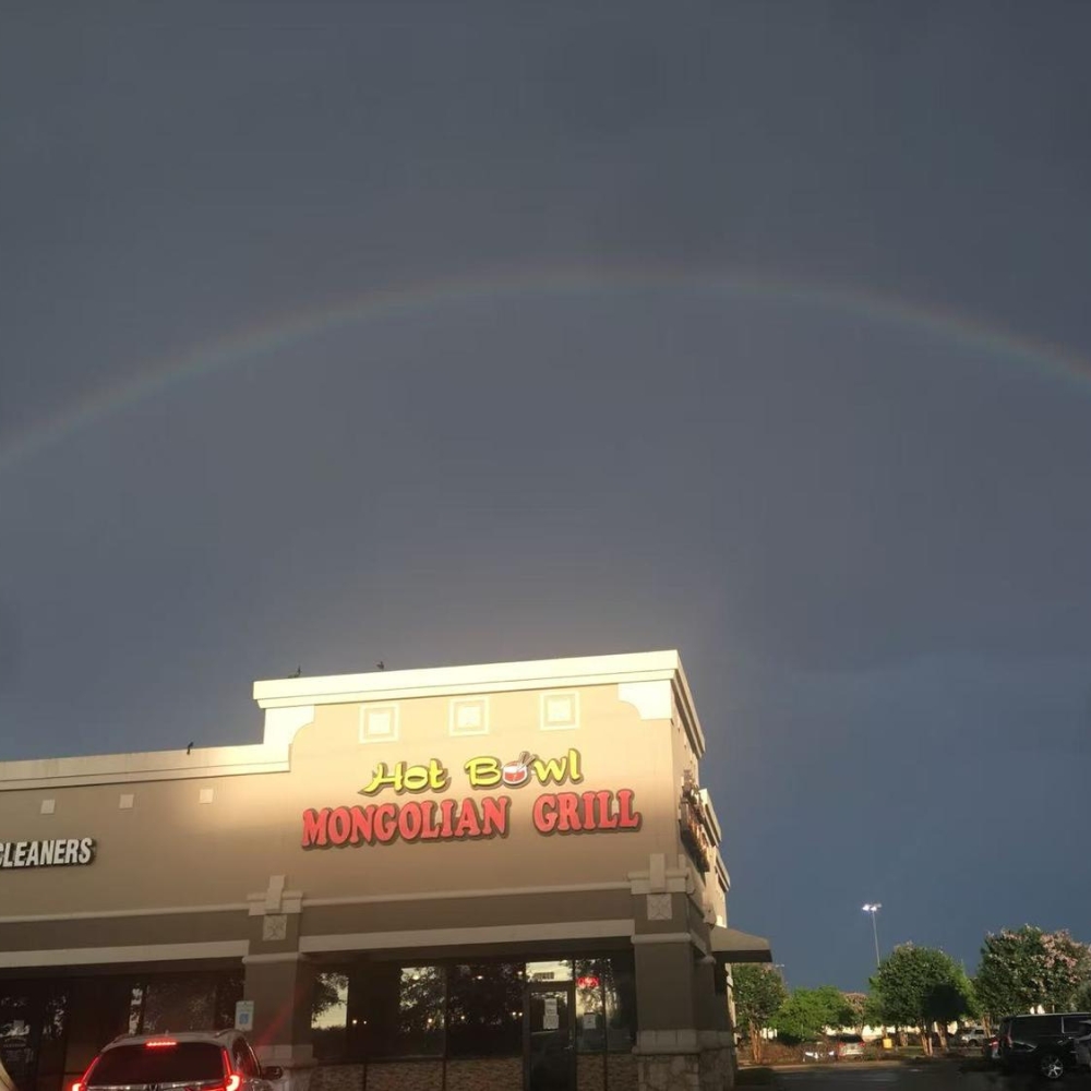 Exterior of Hot Bowl Mongolian Grill with a rainbow in the sky in Sugar Land