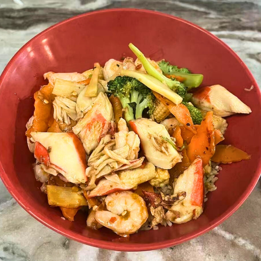 A stir-fry bowl with crab, shrimp, various vegetables, and rice at Hot Bowl Mongolian Grill, a Mongolian Barbecue Restaurant in Sugar Land