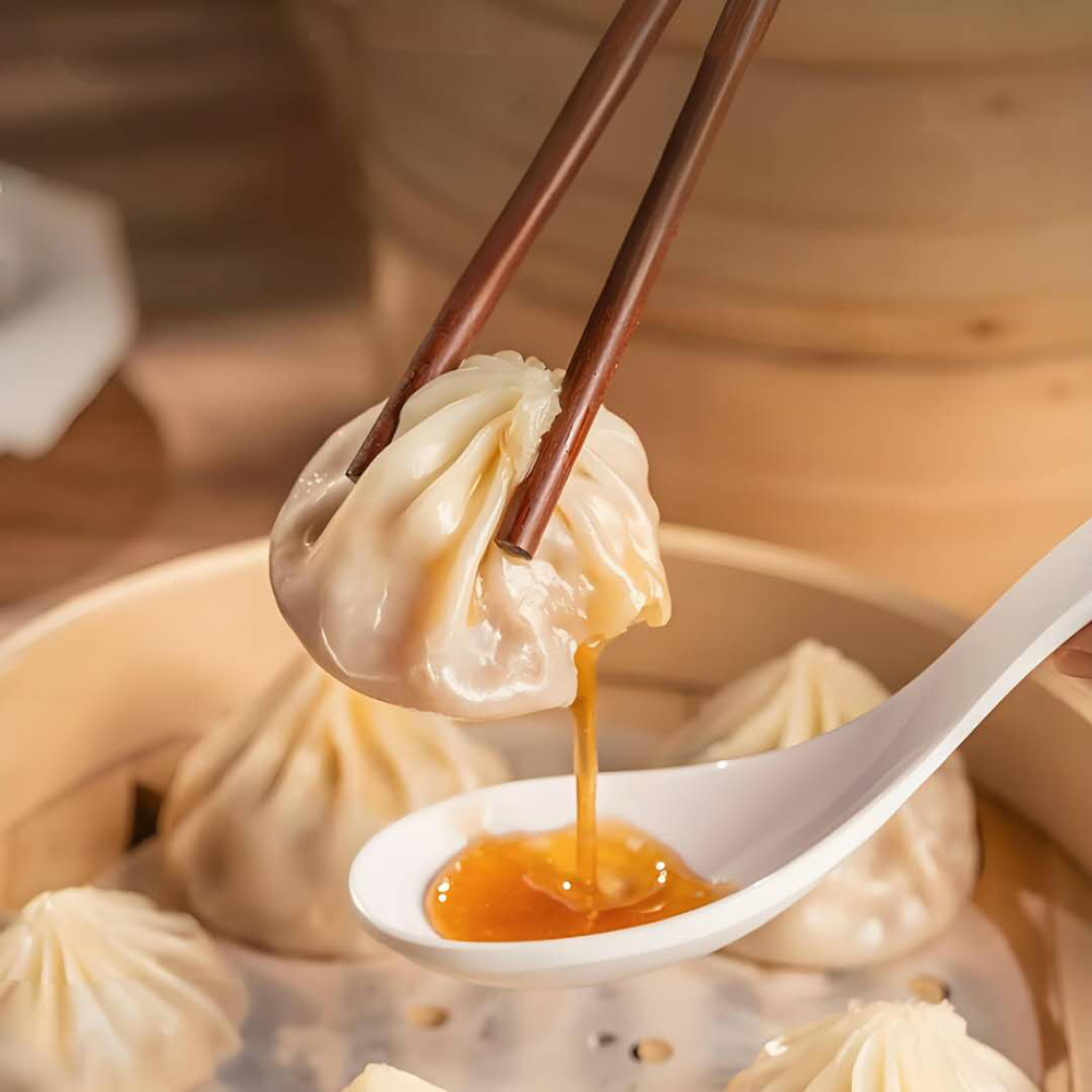 Delicate steamed soup dumplings with juicy pork filling at Hot Dumpling, a Chinese restaurant in Lake Forest