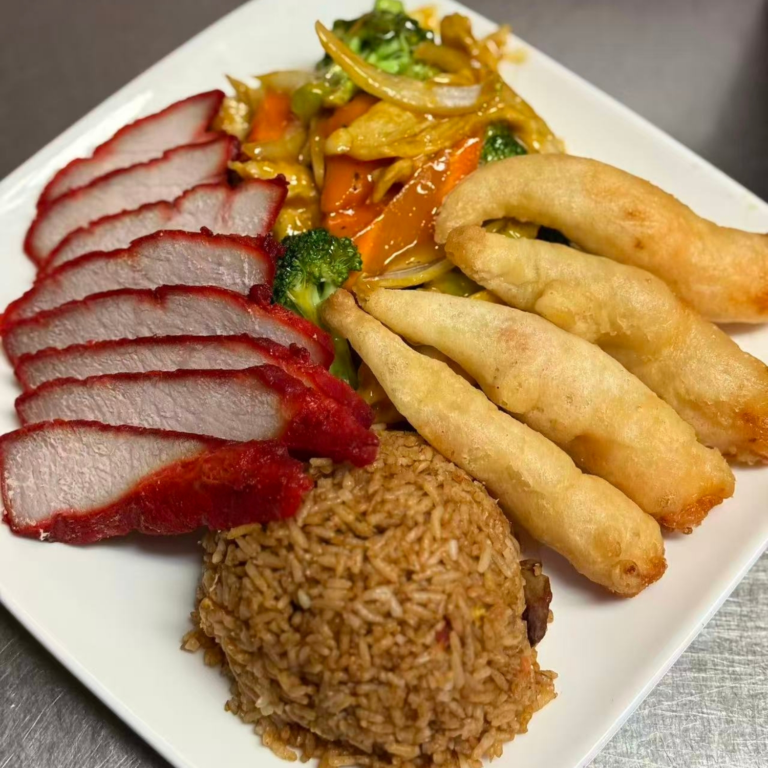 Combination platter with roast pork, fried shrimp and fried rice