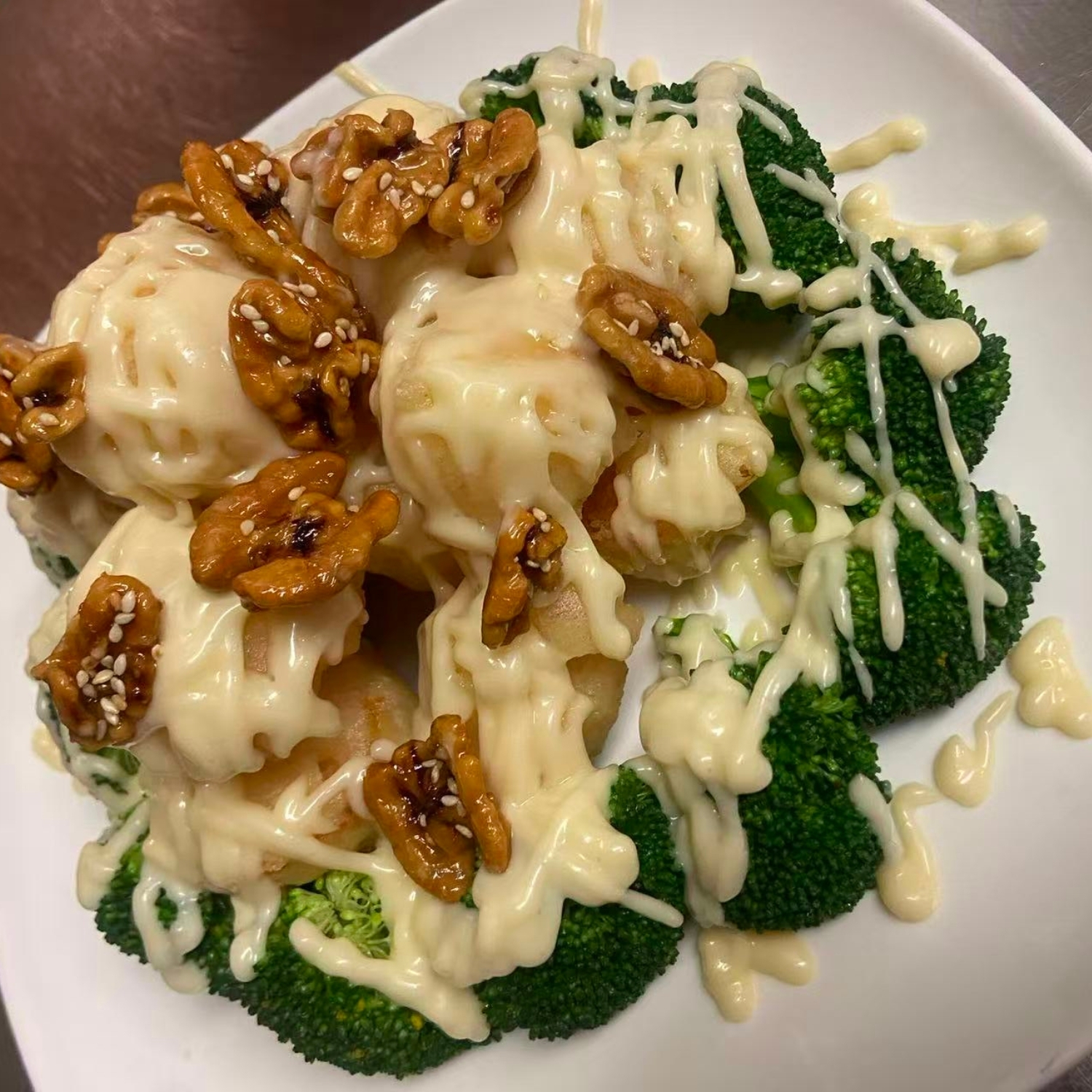 Honey walnut shrimp with creamy sauce and broccoli