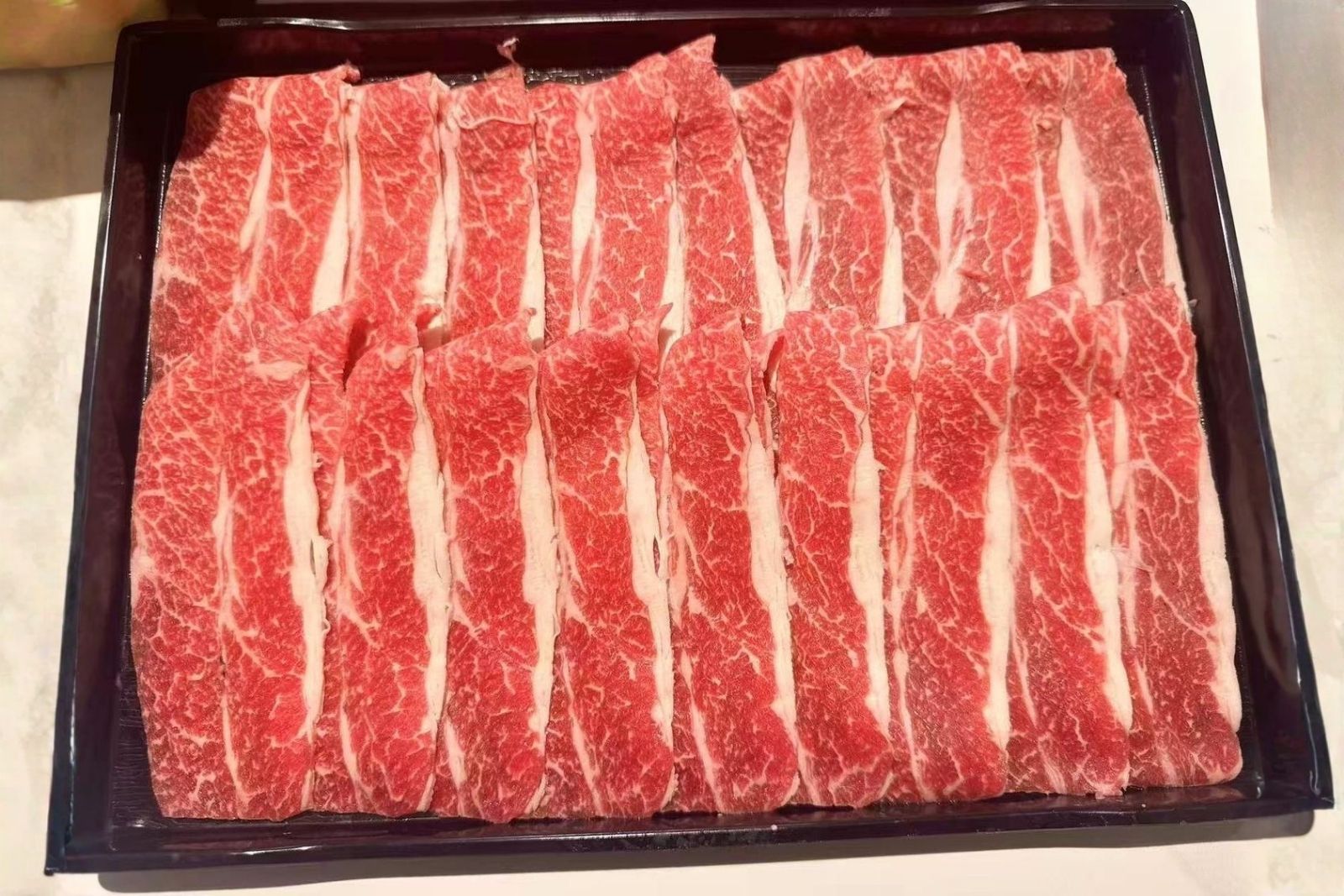 Thinly sliced marbled beef hot pot ingredient at Hotpot Bay, a Chinese Hot Pot Restaurant in San Francisco