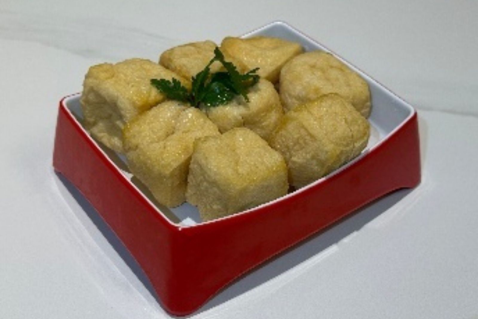 Fried tofu puffs hot pot ingredient with cilantro at Hotpot Bay, a Chinese Hot Pot Restaurant in San Francisco