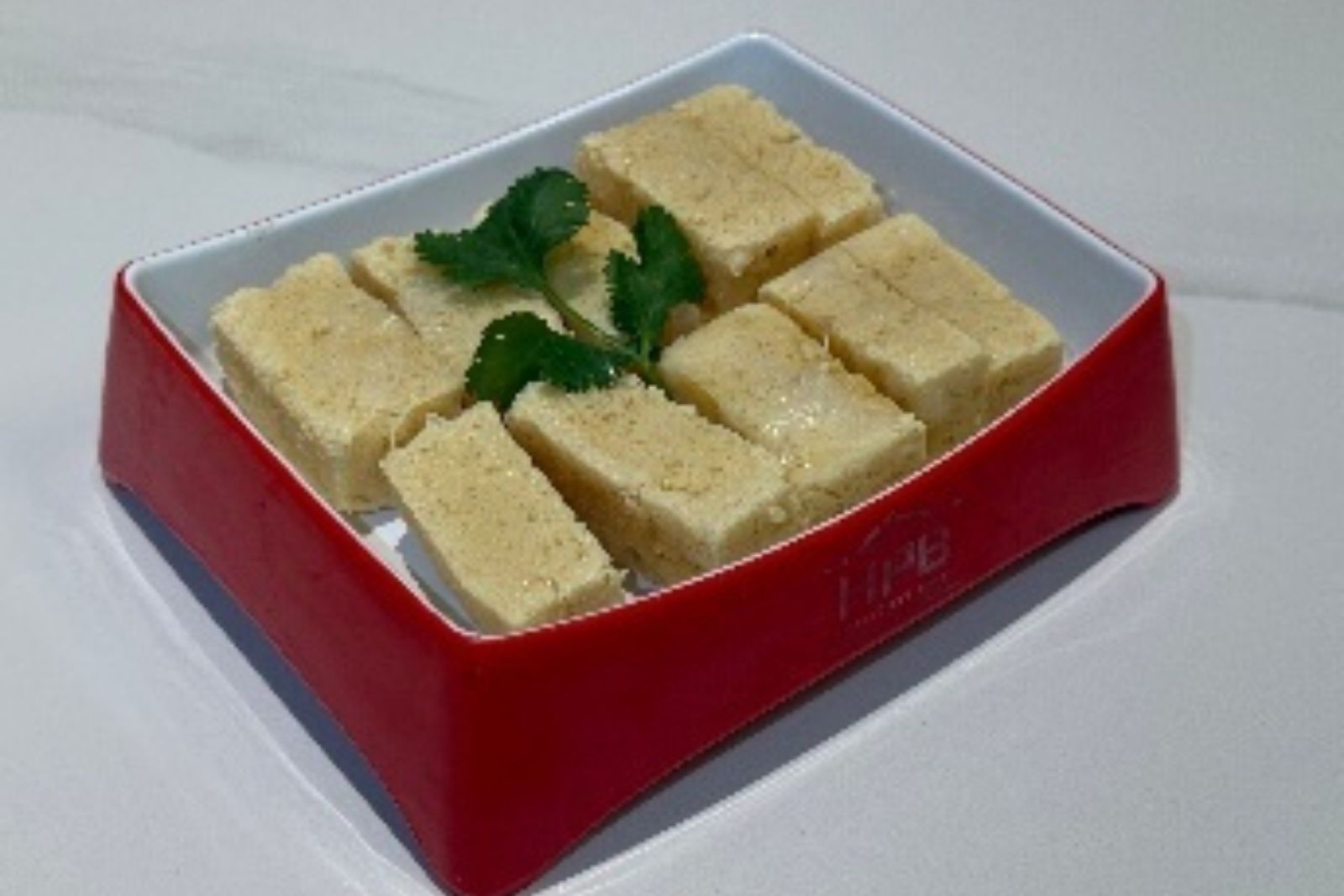 Sliced fried tofu hot pot ingredient with cilantro at Hotpot Bay, a Chinese Hot Pot Restaurant in San Francisco