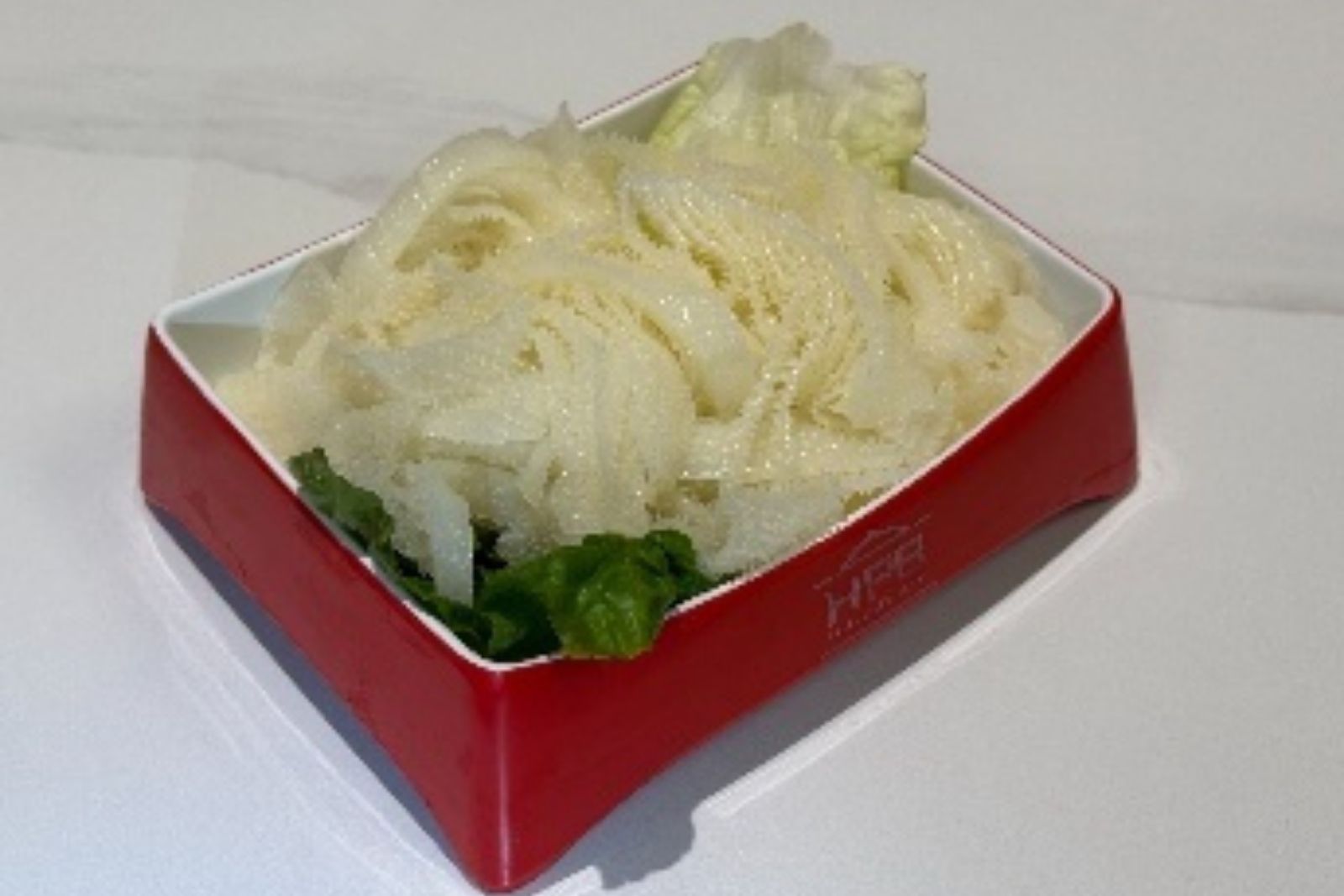 Sliced tripe hot pot ingredient served with lettuce at Hotpot Bay, a Chinese Hot Pot Restaurant in San Francisco