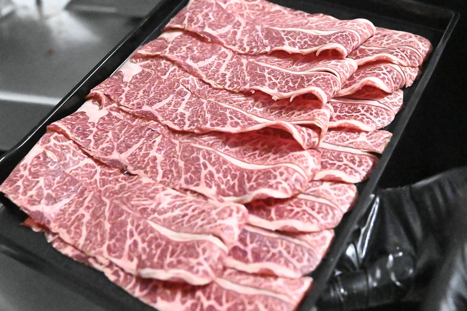 Spicy marinated beef hot pot ingredient with cilantro at Hotpot Bay, a Chinese Hot Pot Restaurant in San Francisco