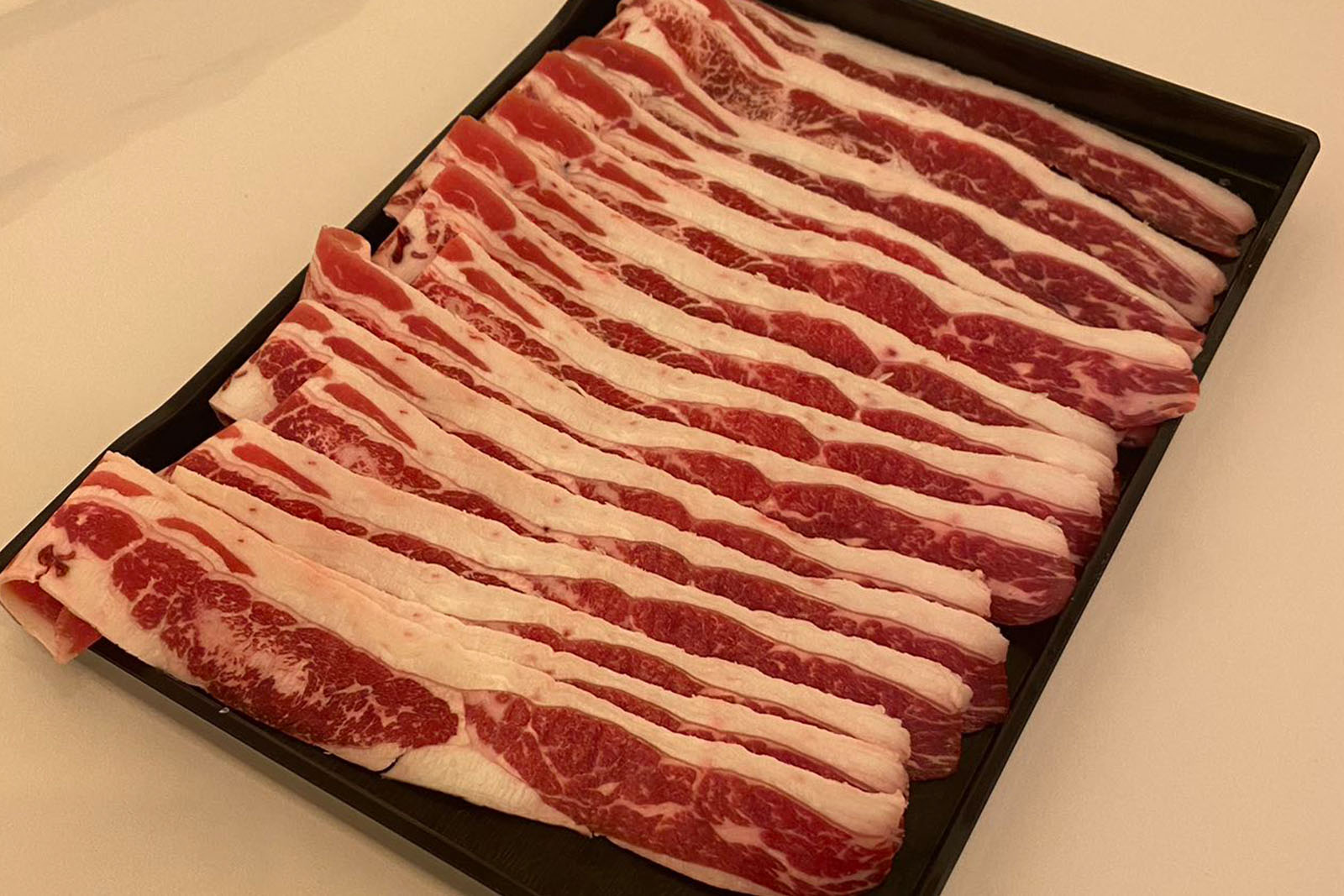 Pork slices with egg yolk hot pot ingredient at Hotpot Bay, a Chinese Hot Pot Restaurant in San Francisco