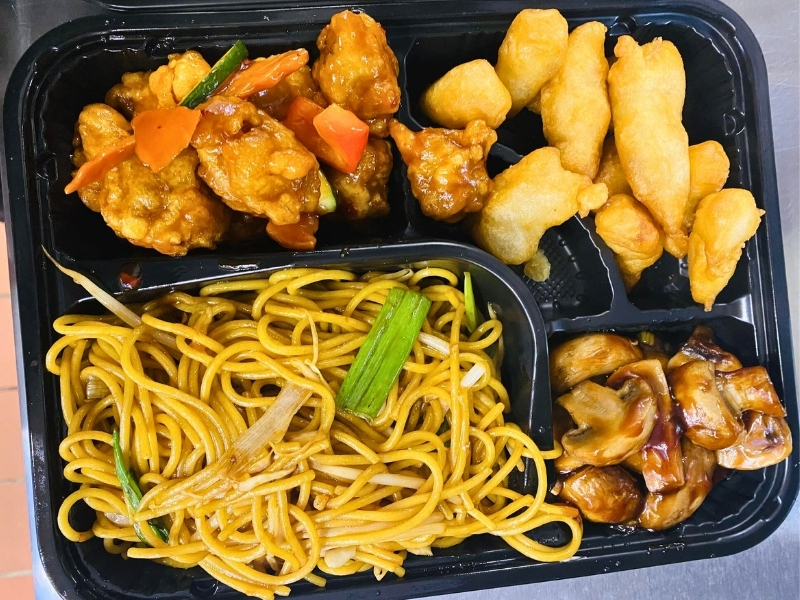 Noodle bento with chicken dishes and veggies at Hoya Asian Express, a Chinese Restaurant in Watertown
