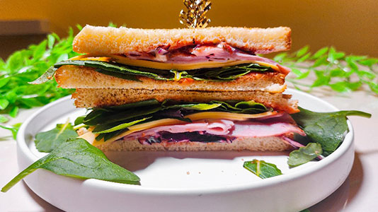 Double-decker ham cheese sandwich with toasted bread at TOZZARELLA, a Dessert restaurant in College Point
