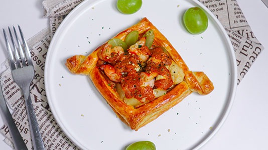 Spicy shrimp puff pastry tart with green grapes at TOZZARELLA, a Dessert restaurant in College Point