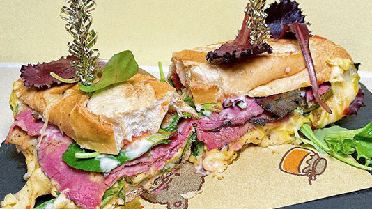 Two savory roast beef sandwiches with melted cheese at TOZZARELLA, a Dessert restaurant in College Point