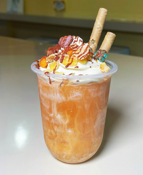 Orange whipped cream frappe with candy toppings at TOZZARELLA, a Dessert restaurant in College Point