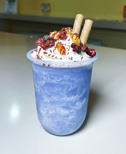 Blue whipped cream frappe with nuts and wafer sticks at TOZZARELLA, a Dessert restaurant in College Point