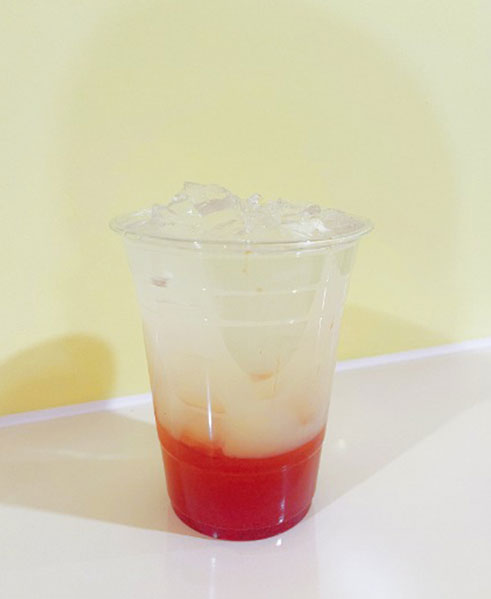 Iced layered drink with red bottom and light top layers at TOZZARELLA, a Dessert restaurant in College Point