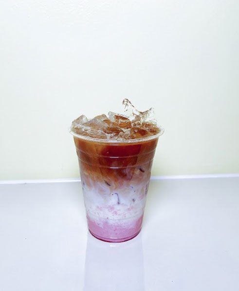 Layered iced coffee drink with pink base at TOZZARELLA, a Dessert restaurant in College Point