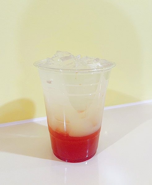 Layered red and clear iced drink in a plastic cup at TOZZARELLA, a Dessert restaurant in College Point