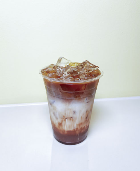 Layered iced coffee with white and brown tones at TOZZARELLA, a Dessert restaurant in College Point