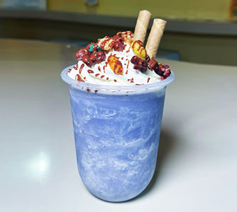 Blue milkshake with whipped cream, candy toppings, wafer sticks at TOZZARELLA, a Dessert restaurant in College Point