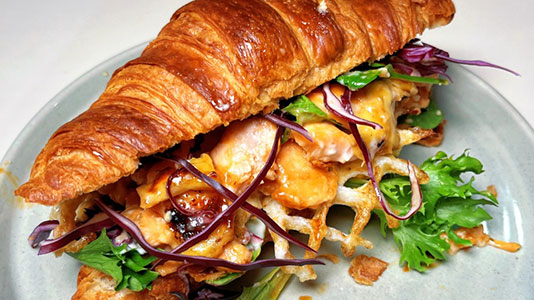 Grilled shrimp croissant sandwich with mixed greens at TOZZARELLA, a Dessert restaurant in College Point
