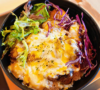 Cheesy baked meat rice bowl with melted cheese, veggies, and greens at TOZZARELLA, a Dessert restaurant in College Point