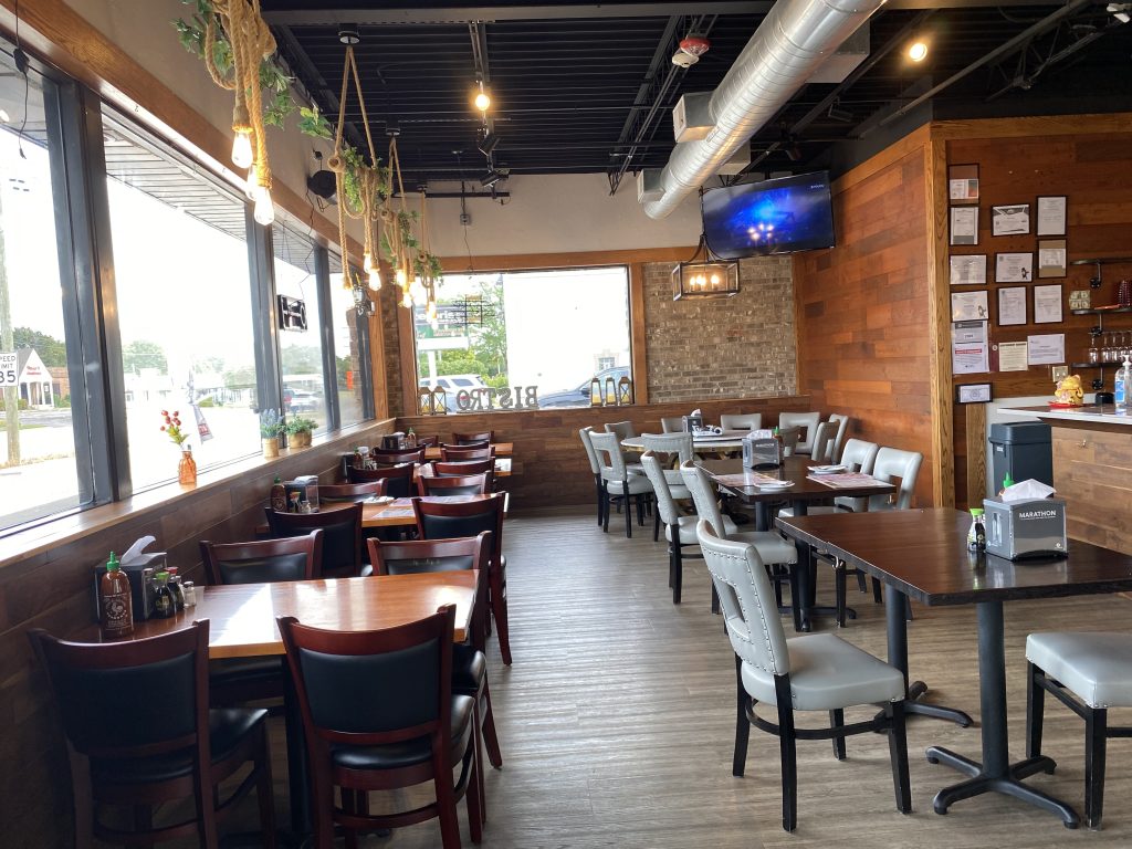 Spacious dining room with warm wooden walls and modern seating at HuNan Impression