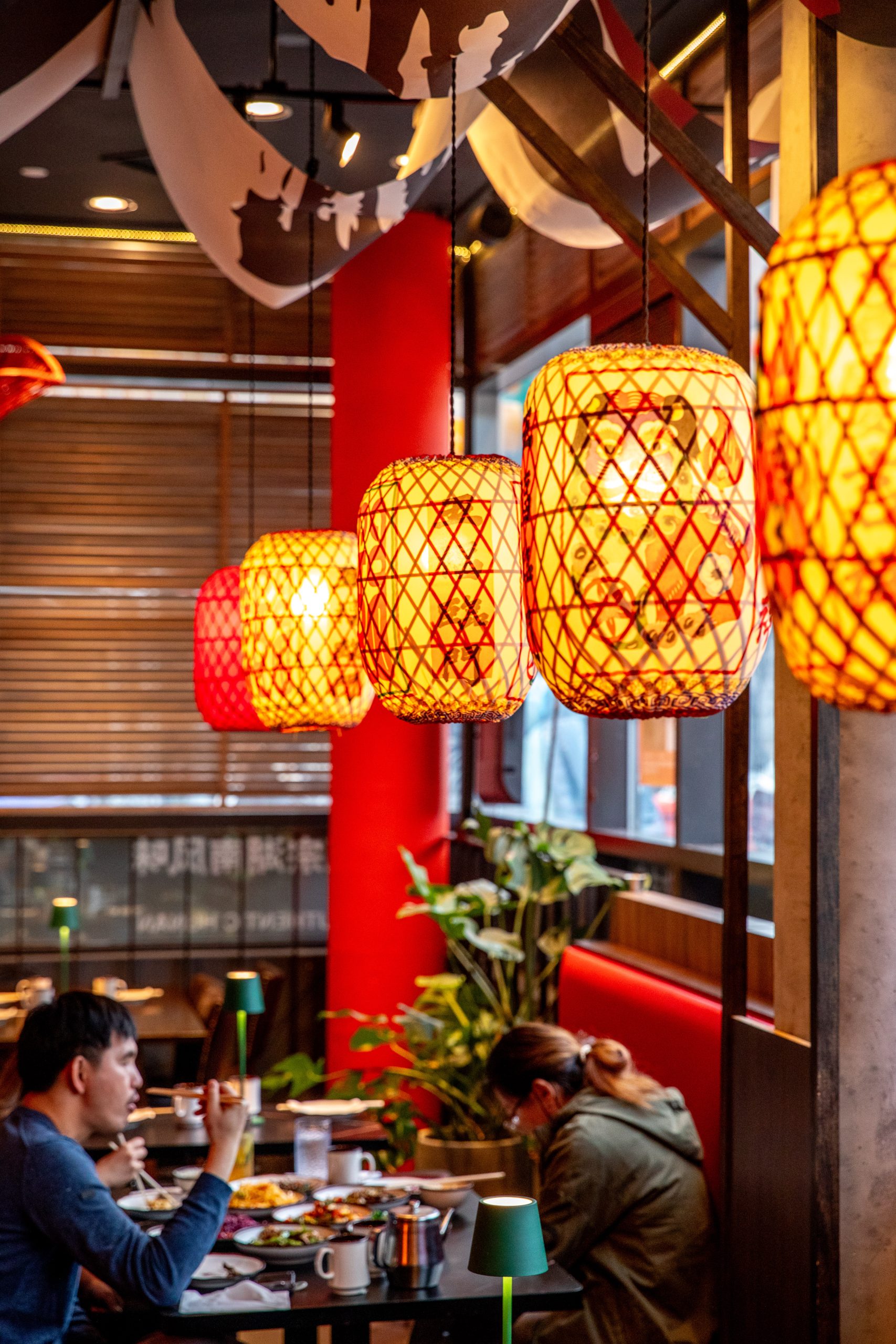 Cozy dining area with red lanterns at Hunan Tapas, an Hunan Restaurant in NY