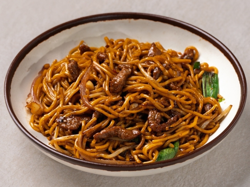 Stir-fried noodles with beef, onions and scallions at Hunan Tapas, an Hunan Restaurant in NY