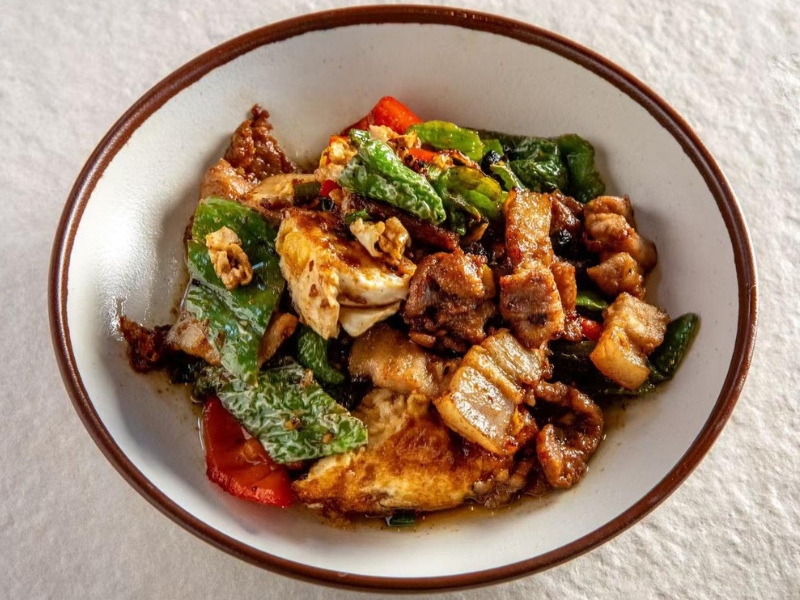 Stir-fried pork belly with fried eggs and green peppers at Hunan Tapas, an Hunan Restaurant in NY