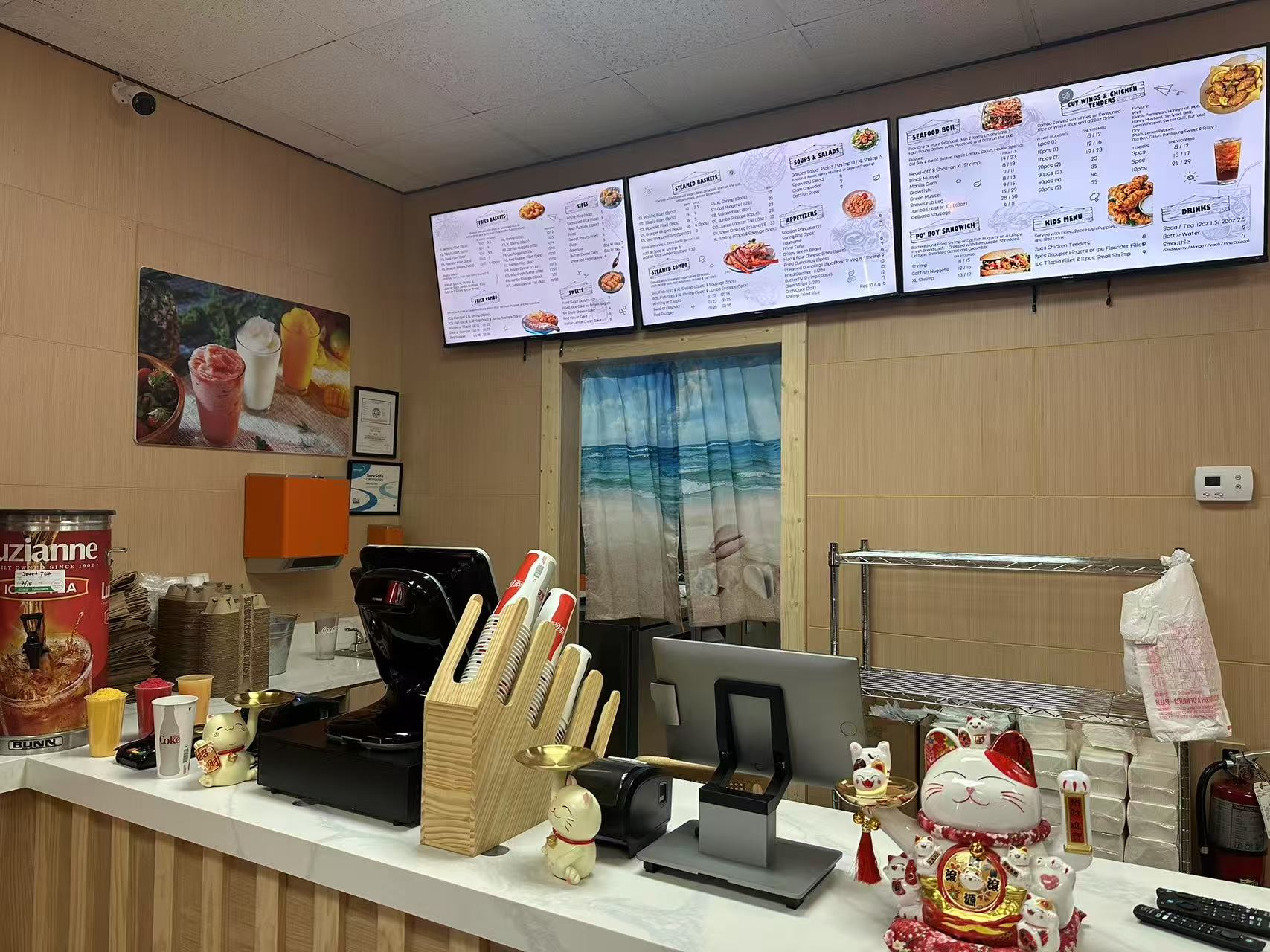 Front counter featuring menu displays, lucky cat figurines, and beverage station.