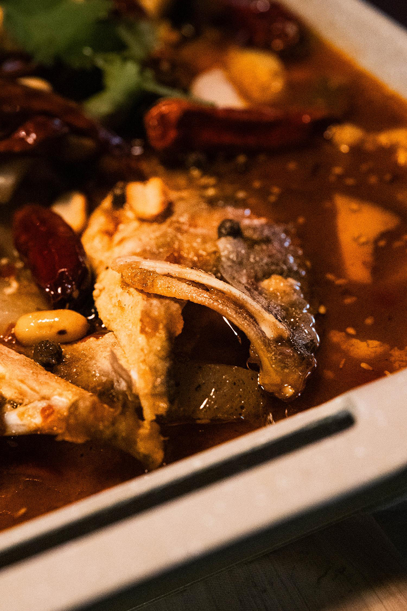 Close-up of Sichuan grilled fish in spicy broth at 梦幻冰季 - ICERA，a Asian Fusion BBQ Restaurant in New York