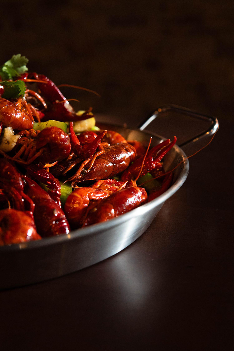 Close-up of glossy spicy crawfish at 梦幻冰季 - ICERA，a Asian Fusion BBQ Restaurant in New York
