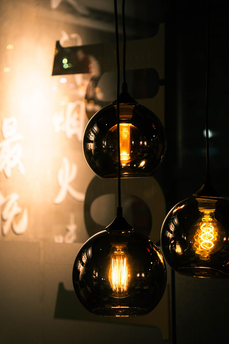Warm amber glass pendant lights with Chinese characters at 梦幻冰季 - ICERA，a Asian Fusion BBQ Restaurant in New York