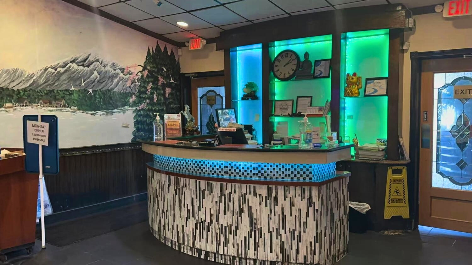 Illuminated front desk with wall murals at ICHIBAN BUFFET, a Buffet Restaurant in Leesburg.