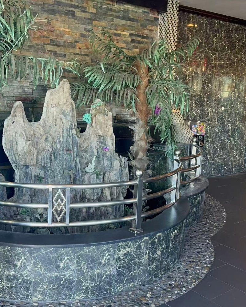 Indoor rock water feature with tropical plants at ICHIBAN BUFFET, a Buffet Restaurant in Leesburg.