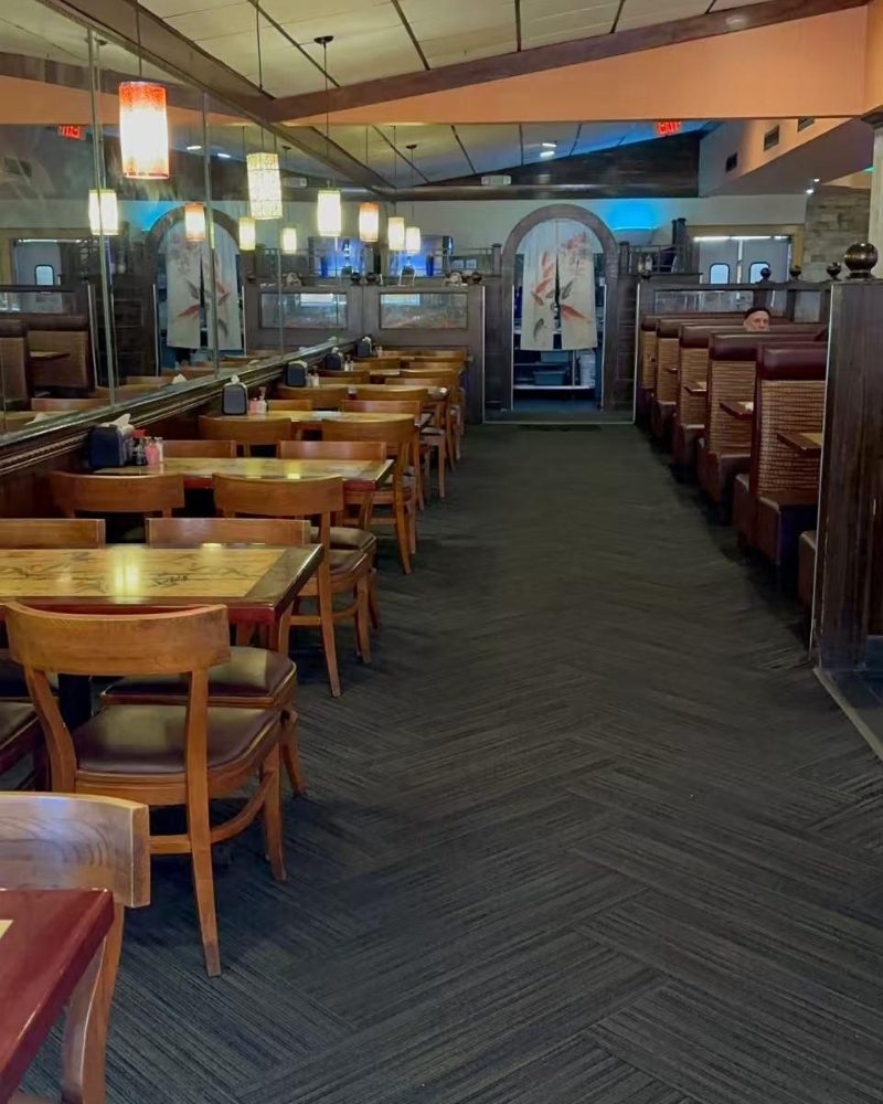 Spacious dining area with wooden tables and booths at ICHIBAN BUFFET, a Buffet Restaurant in Leesburg.