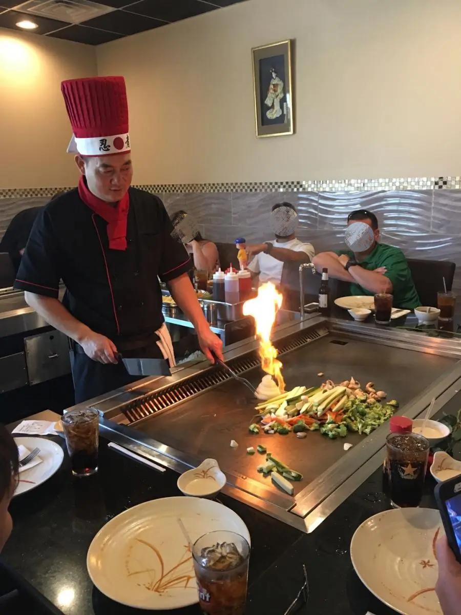 Chef performing hibachi cooking with flames at Ichiban, a Japanese Restaurant in Sheffield