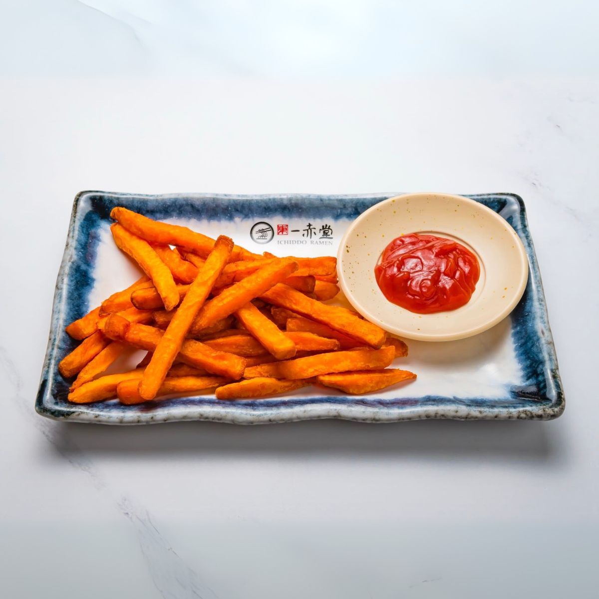 Sweet Potato Fries - Crispy sweet potato fries served with ketchup at Ichiddo Ramen Rochester, a Japanese Restaurant in Rochester